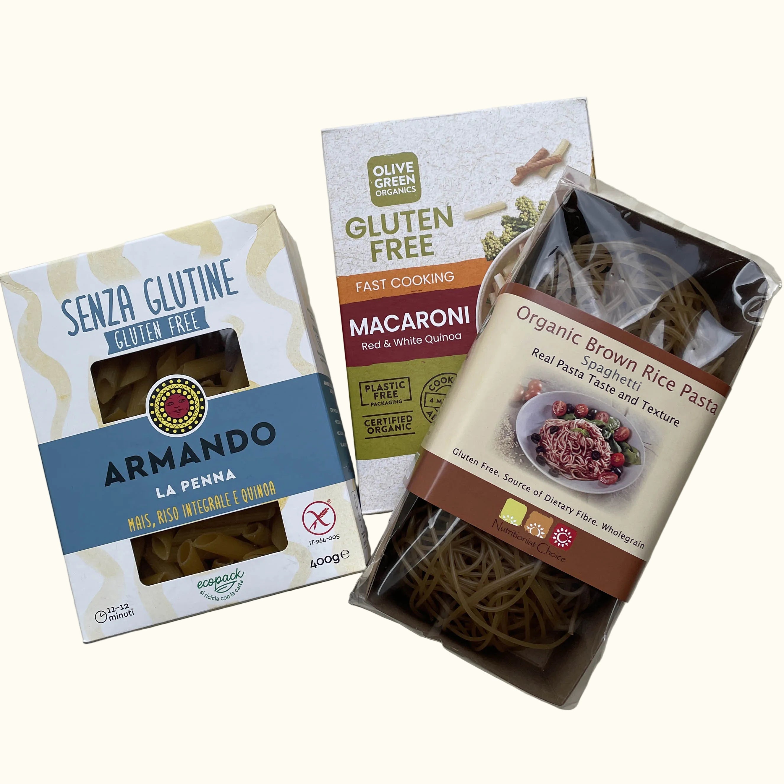 Armando La Penna gluten-free macaroni risotto e quinoa, a box of Olive Green Foods gluten-free fast cooking macaroni, and a clear bag of organic brown rice pasta. 
