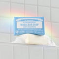 Dr. Bronner's Magic Bar Soap on a white surface with a tiled background