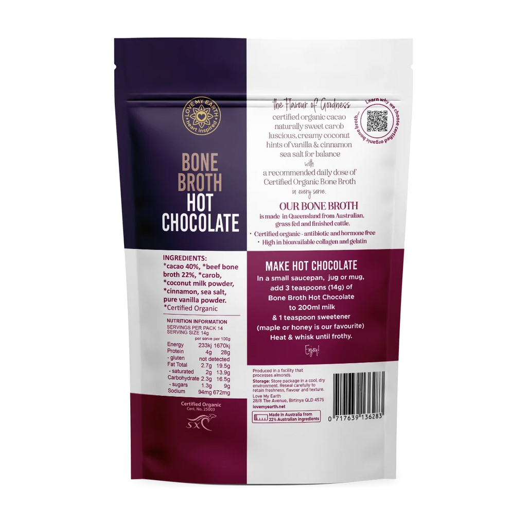 Back view of a Certified Organic Bone Broth Hot Chocolate pouch, featuring a split design with dark purple on the left and white on the right, with text detailing ingredients and preparation instructions.
