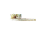Bamboo toothbrush with bristles on a brown background