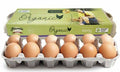 A carton of organic eggs shown open, with brown eggs in a gray plastic tray in front of a light green branded box. The box reads 'Pirovic Organic' and '660g'.